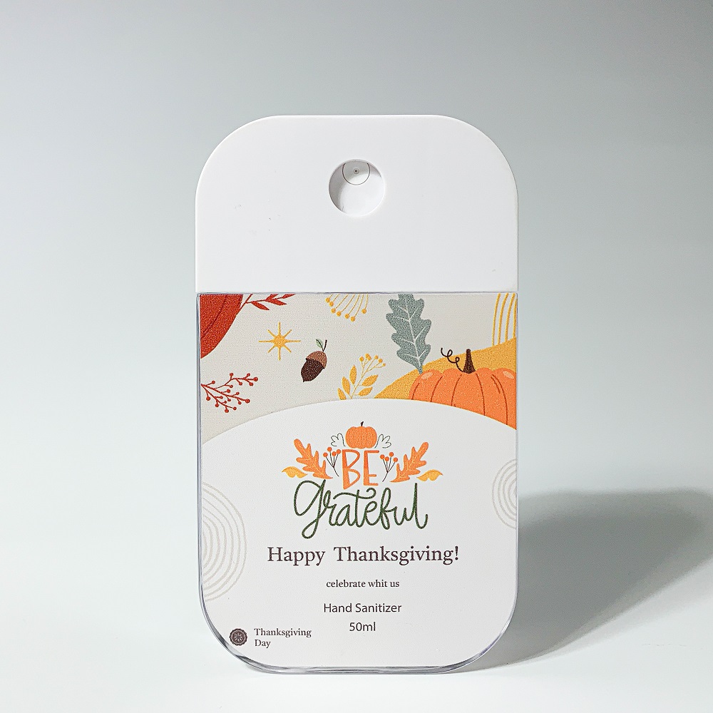 A neatly arranged group of mini spray bottles for perfume, toner, and setting spray displayed on a marble surface