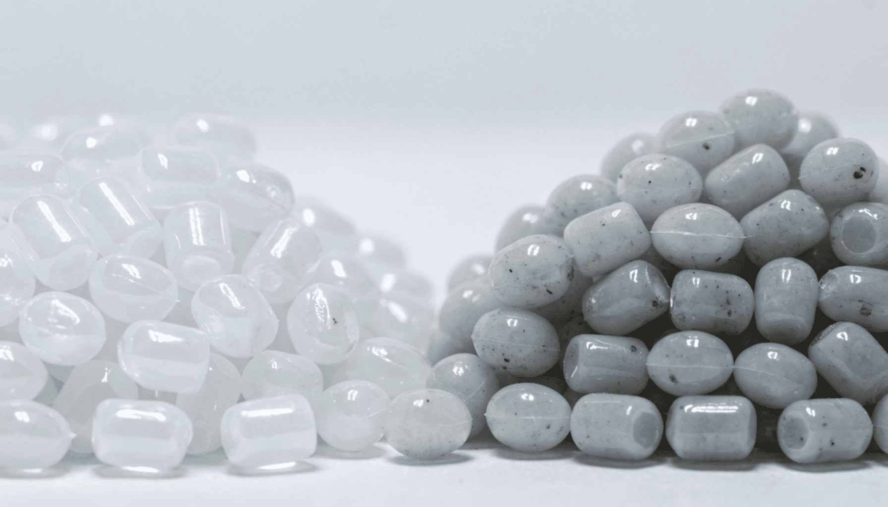 A side by side comparison of clean white virgin plastic pellets and grayish speckled recycled plastic pellets